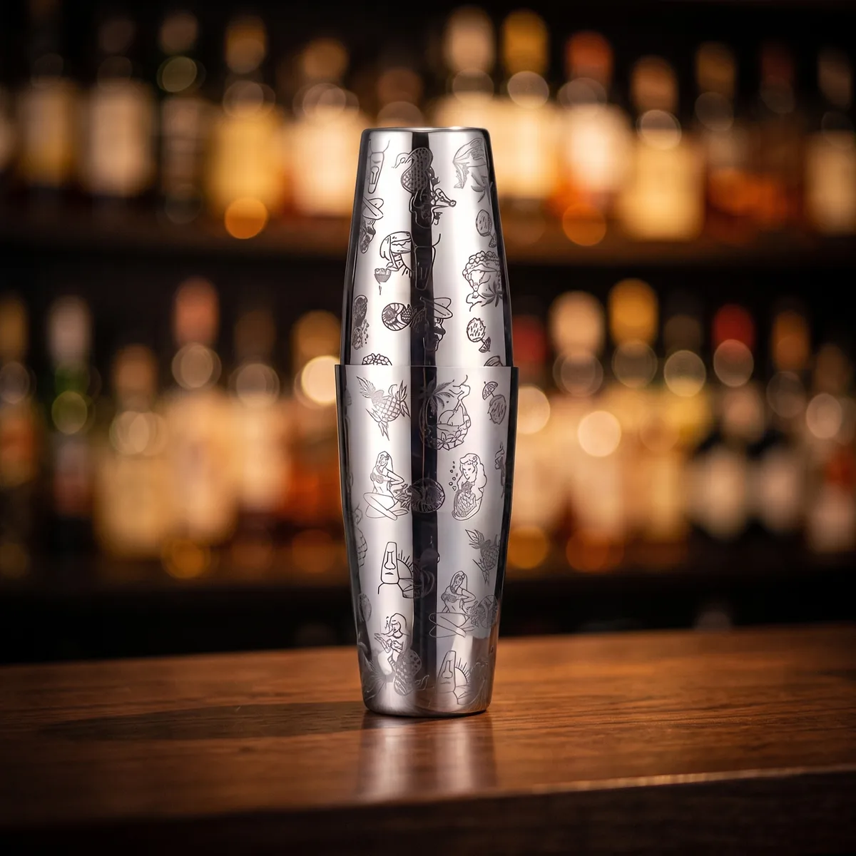 Silver engraved Boston shaker, Hula pattern, on a bar counter