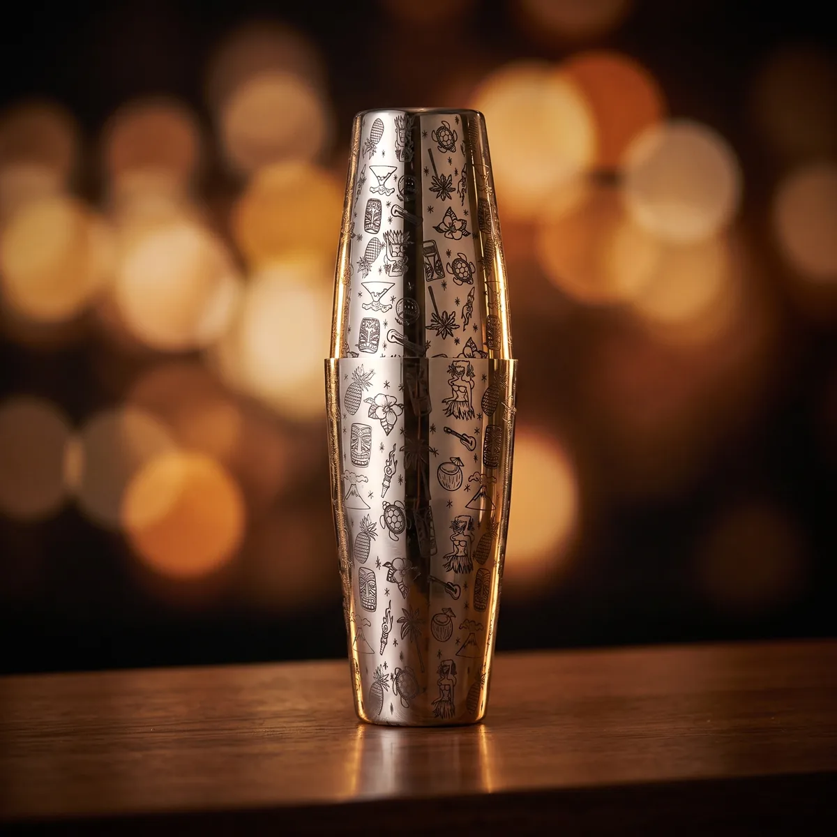 Silver engraved Boston shaker, Tiki pattern, on a bar counter