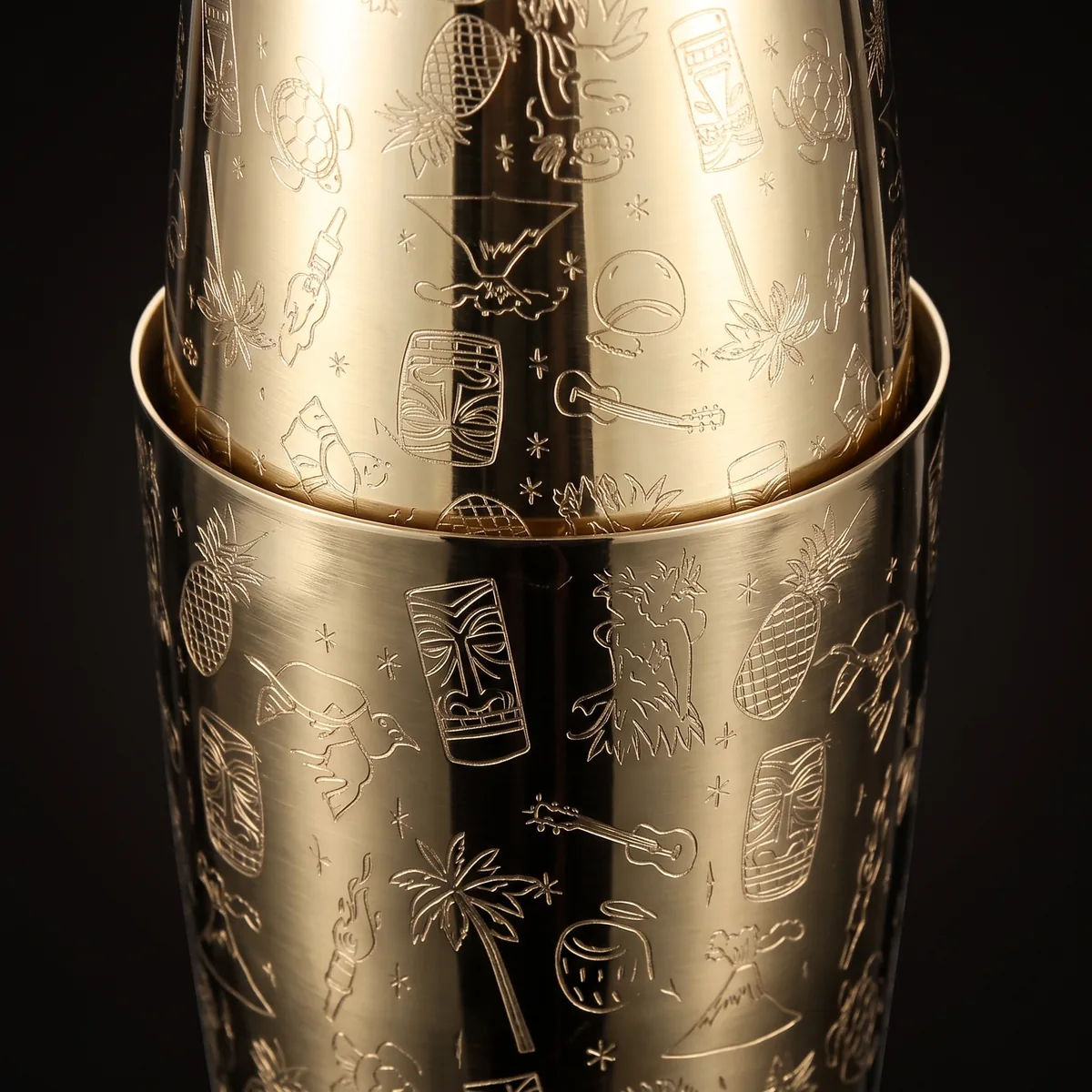 Gold engraved Boston shaker, Tiki pattern, three-quarter view
