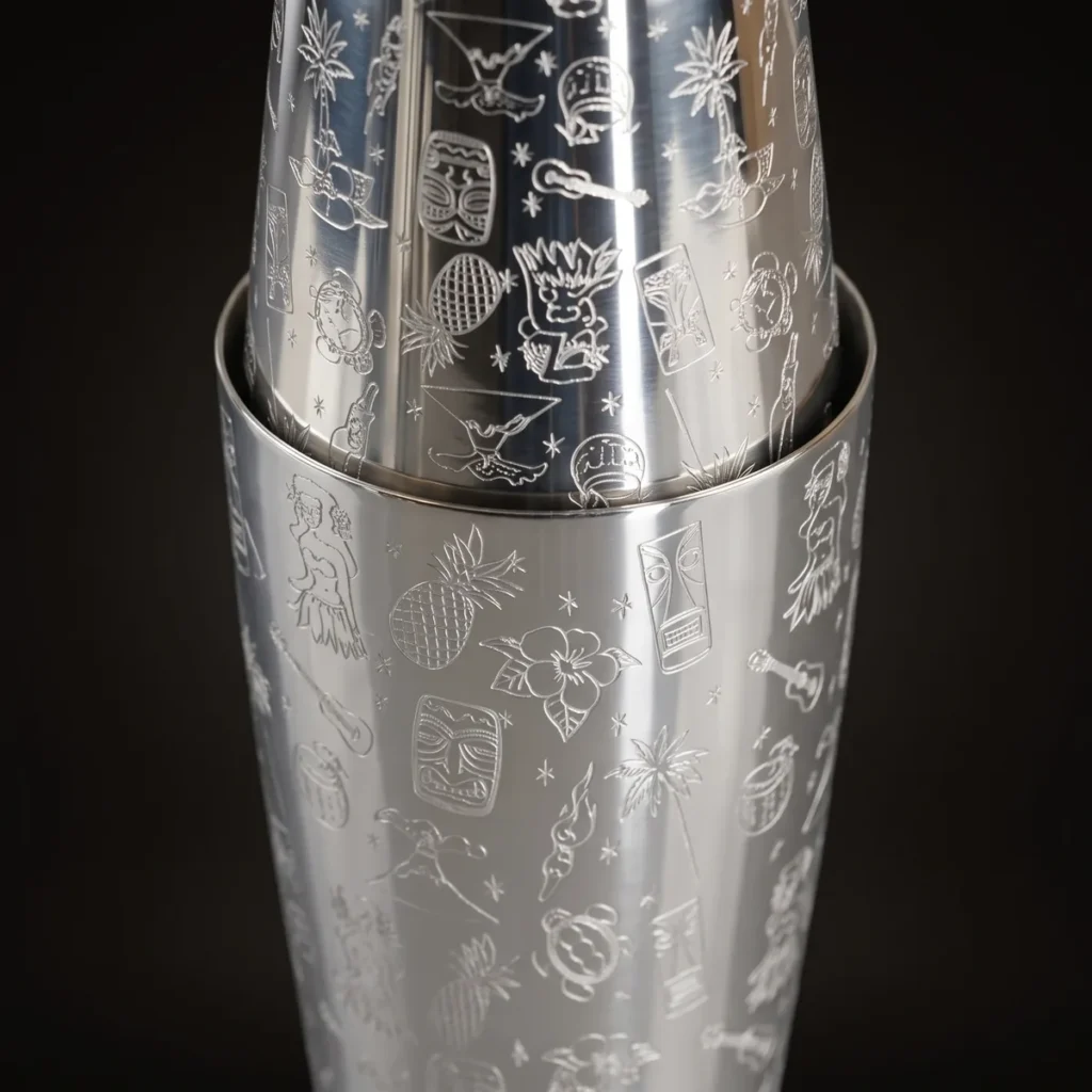 Engraved Boston shaker, Hawaiian pattern, three-quarter view