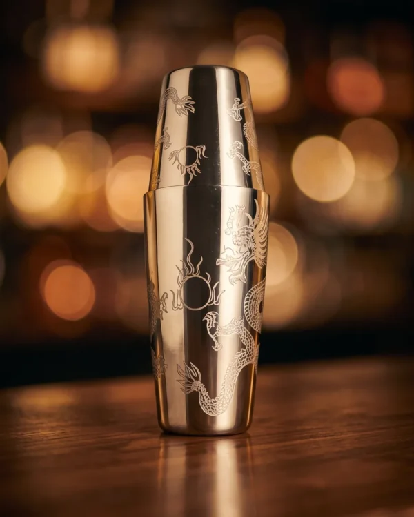 Finely engraved Boston shaker, dragon pattern, on a bar counter