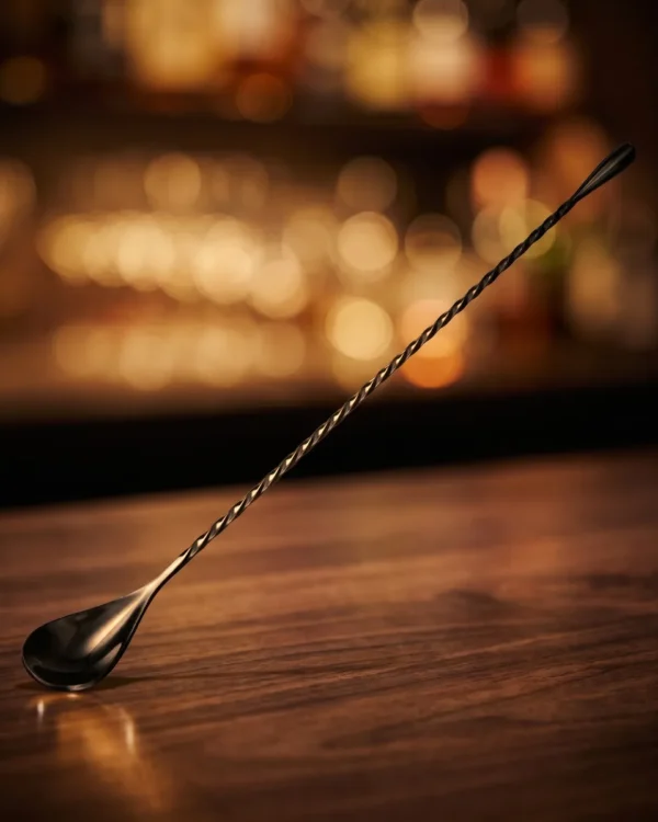 Twisted bar spoon 30 cm, black, on a bar counter