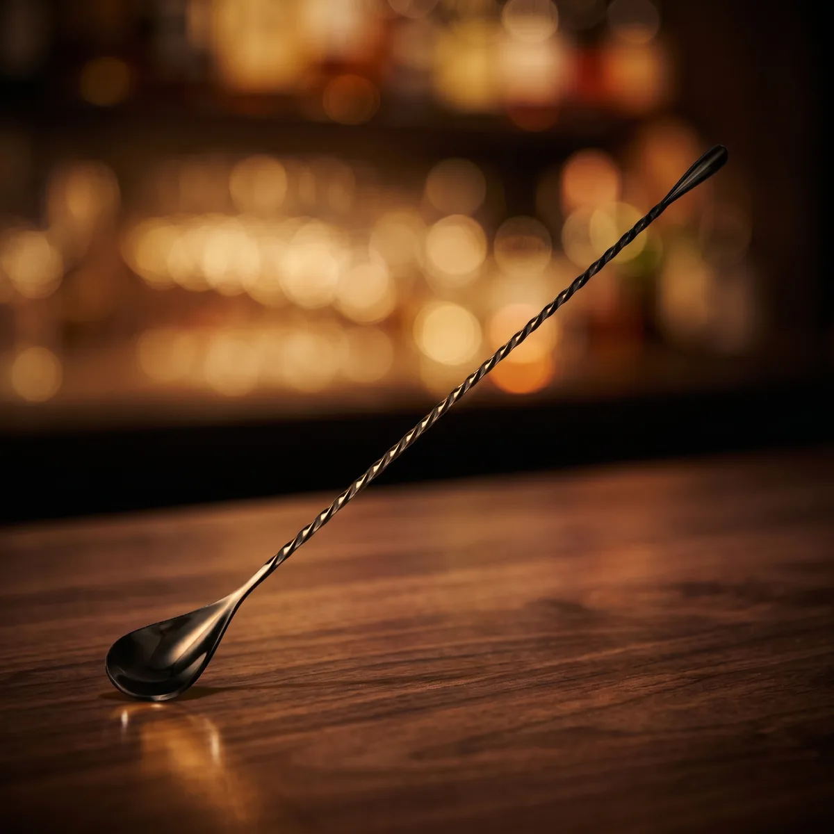 Twisted bar spoon 30 cm, black, on a bar counter