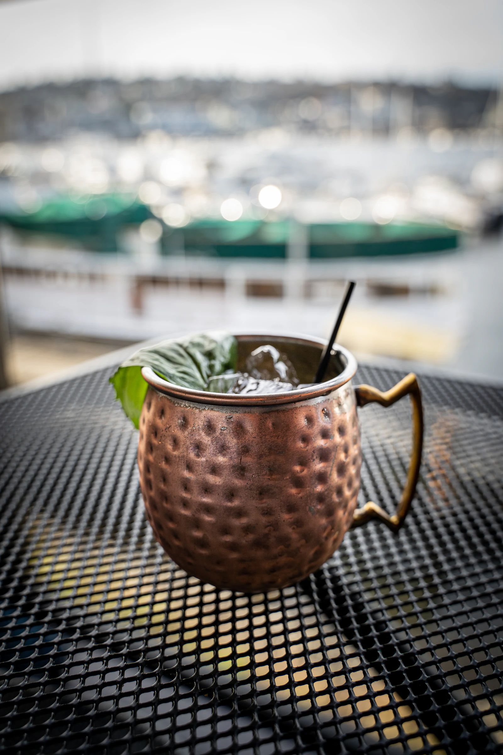 Moscow Mule served in a hammered copper mug with ice, mint and a straw