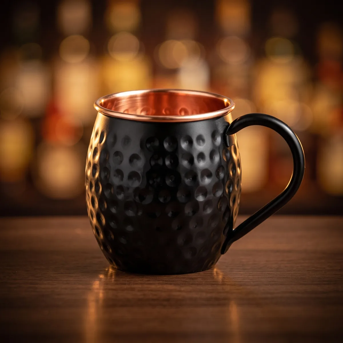 Black copper Moscow Mule mug, on a bar counter