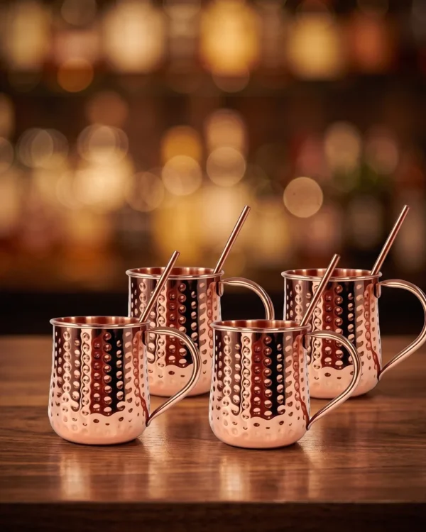 Copper Moscow Mule mugs and straws, set of 4, on a bar counter