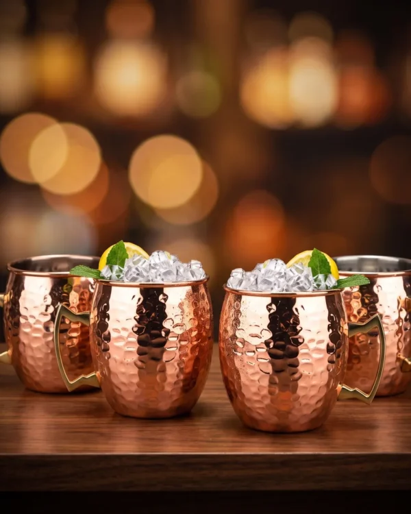 Hammered copper Moscow Mule mugs, set of 4, on a bar counter