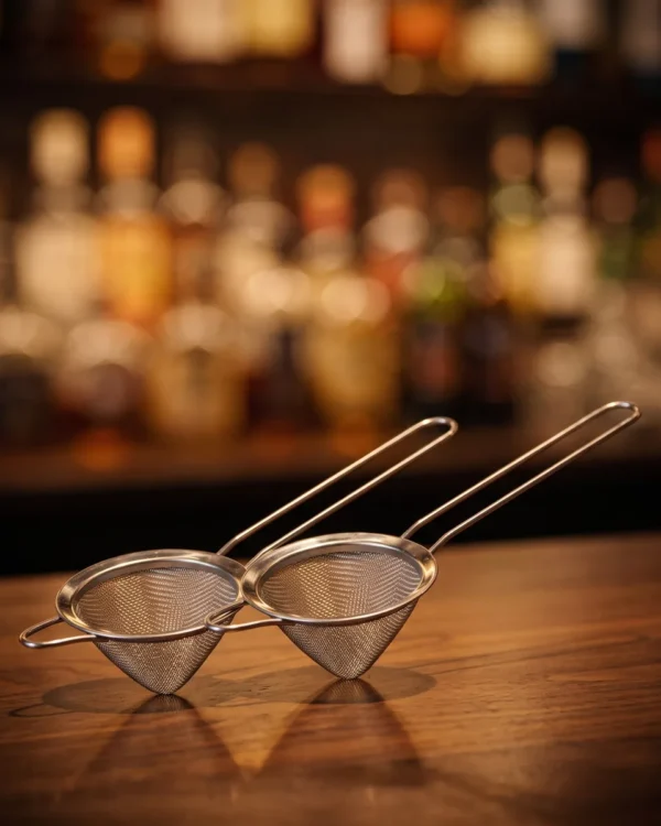 Conical fine strainers, set of 2, on a bar counter
