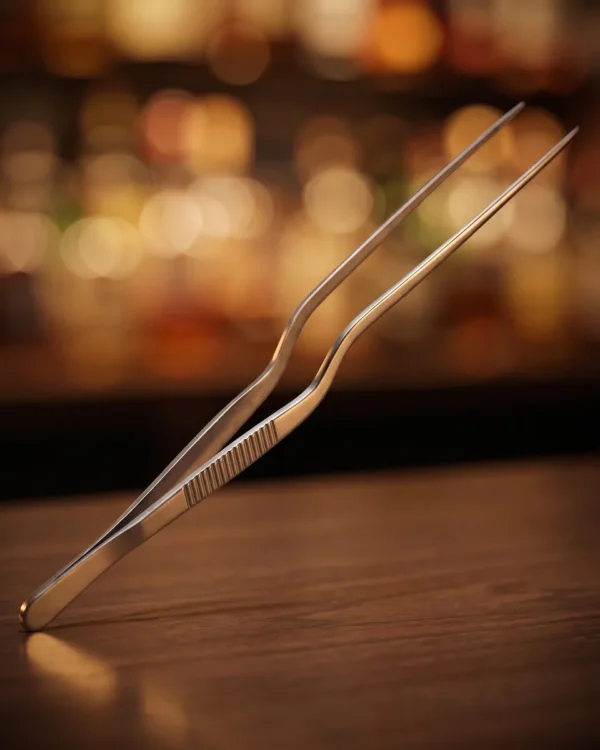 Stainless steel garnish tongs 26 cm, on a bar counter
